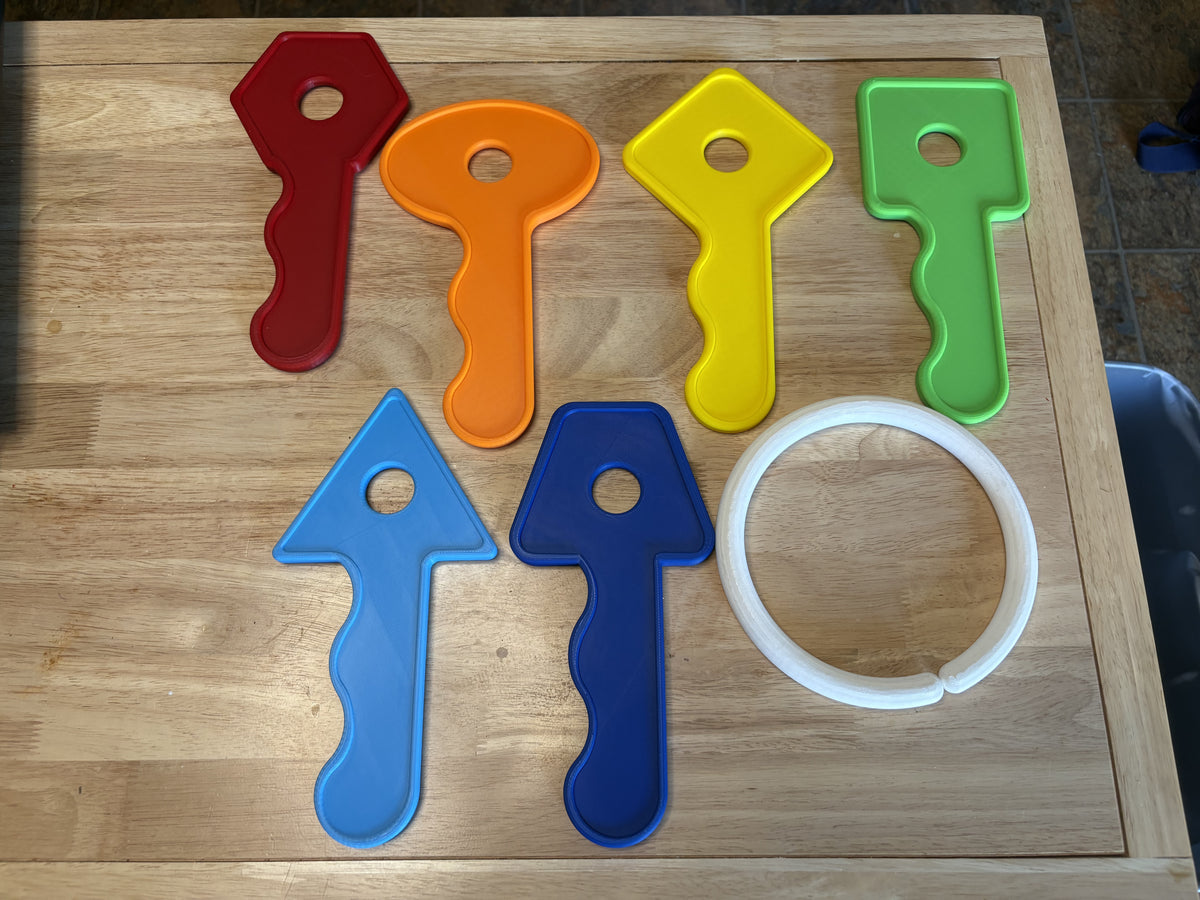 Set of colorful plastic tools on a wooden surface